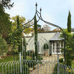 gothic arch in country garden at the entrance of a front house 