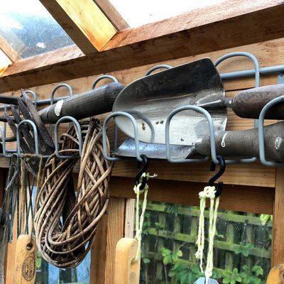 tool rack with tools on in shed